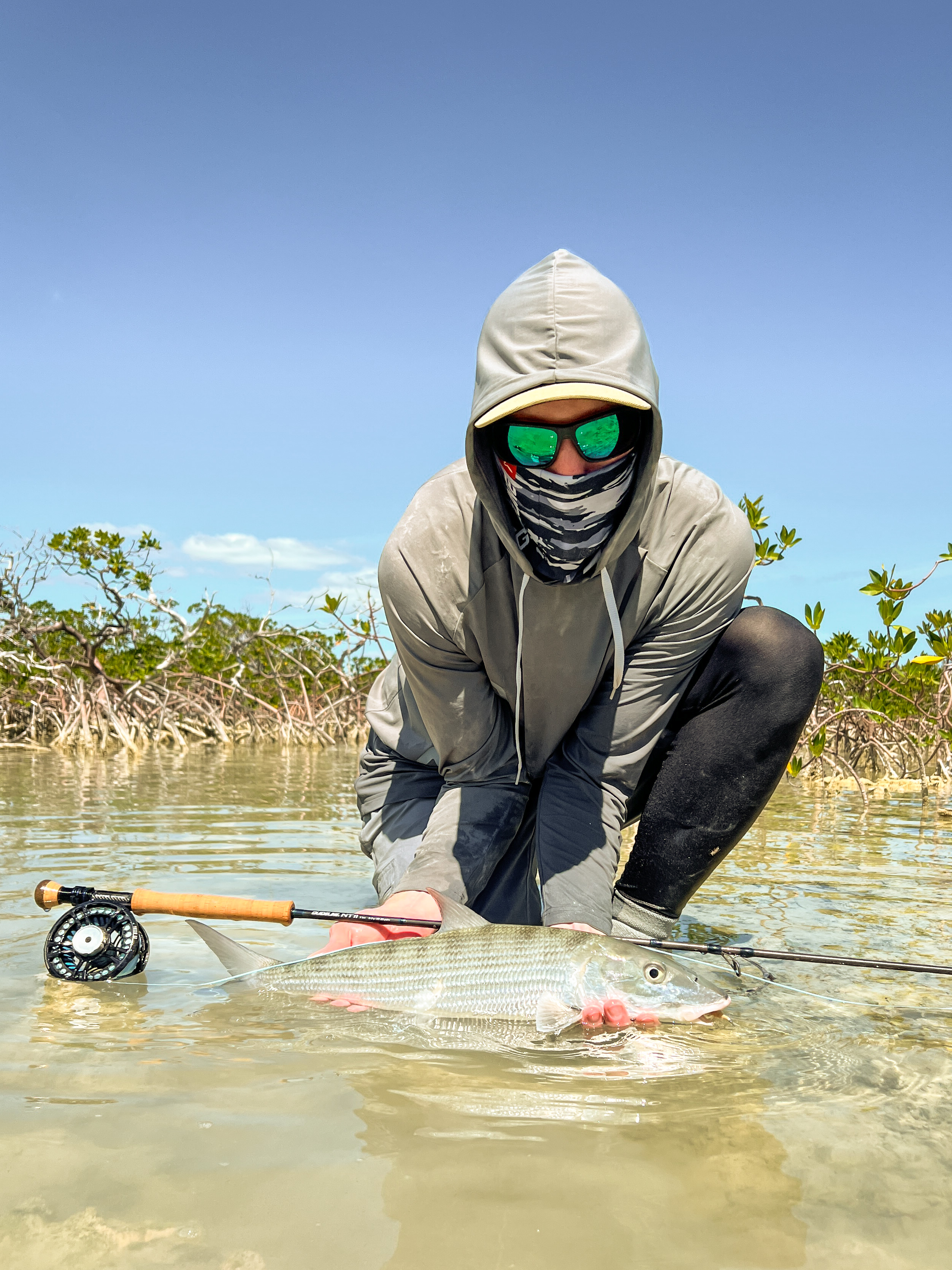 Fly angler posing with a nice bonefish in the mangroves of the Bahamas.